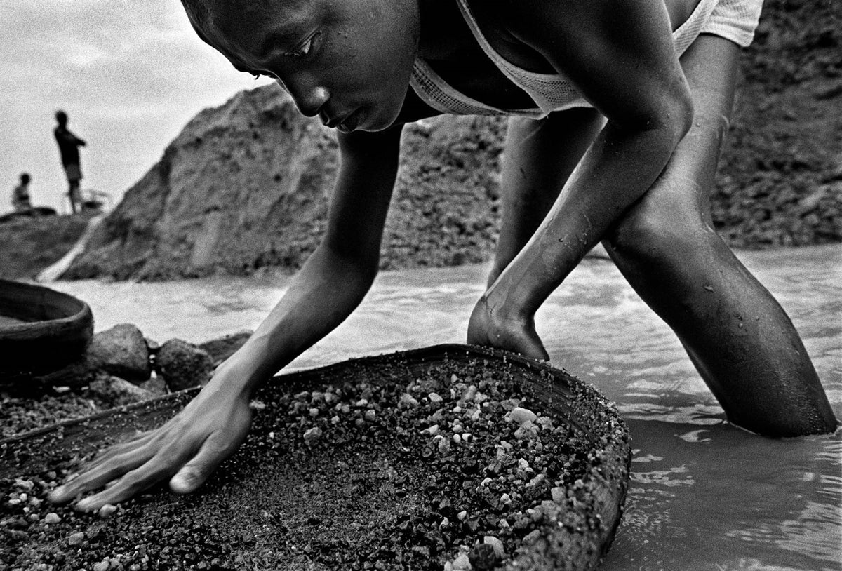 A boy sifts for diamonds.